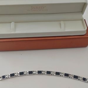 Jarred bracelet. Stainless steel and carbon fiber.